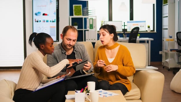 A financial advisor explaining Social Security benefit options to a diverse couple in a modern office setting, emphasizing strategic planning.