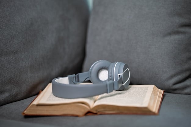 An open book on a desk with a pair of headphones next to it, symbolizing accessible learning and technology integration in education.