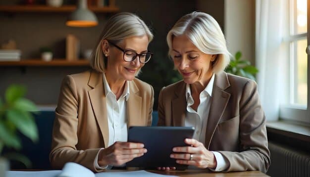 An elderly woman sitting with an adult financial advisor, looking at a tablet displaying graphs and financial projections.