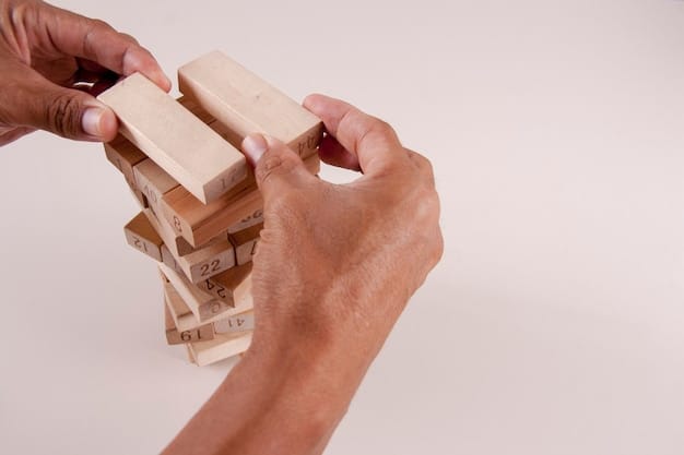 A person's hand stacking small wooden blocks, representing the step-by-step process of rebuilding finances and credit after bankruptcy.