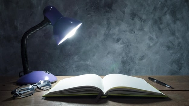 An open textbook on a desk, with a spotlight illuminating a section on 